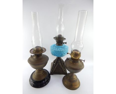 A Victorian cast iron and turquoise opaline glass oil lamp, two Duplex brass oil lamps and three glass flumes.