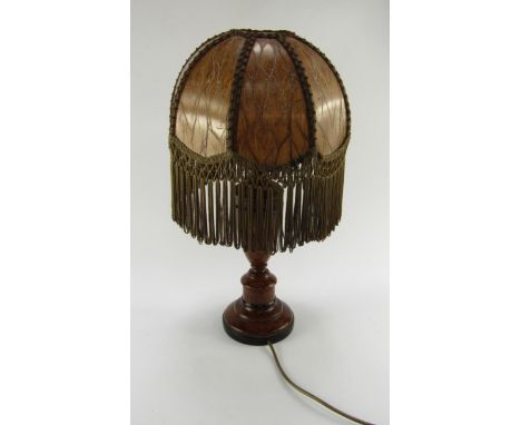 A baluster table lamp with a scumble finish, faux skin and tasseled shade, 50cm high.