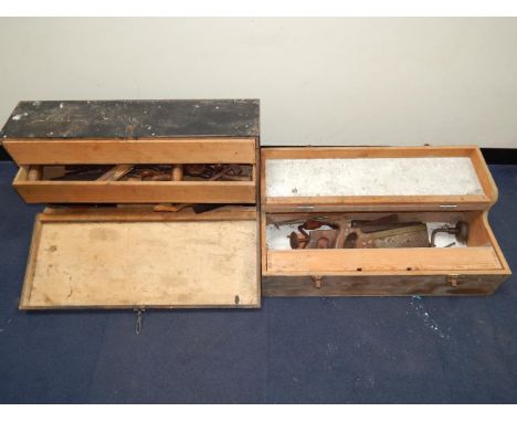 Two tool chests containing saws, braces, planes and other carpentry tools.