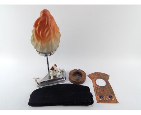 A Newlyn School type copper clock fascia, Art Deco chrome table lamp surmounted with a puppy, frosted flame glass shade, oak 