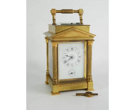 A late 19thC brass cased repeater carriage clock, of architectural temple form, rectangular enamel dial bearing Roman numeral