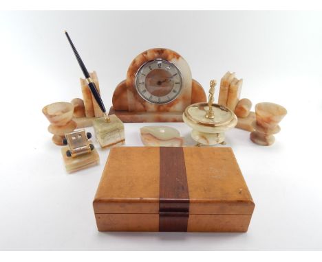 An Art Deco brown onyx mantel clock, pair of vases, pair of bookends, two green onyx ashtrays, pen holder and desk calendar, 