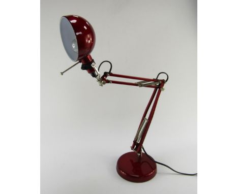 A red metal anglepoise lamp, 70cm high.