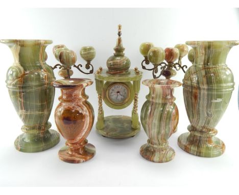 A 1970's onyx mantel clock of temple form, with a quartz movement, two pairs of vases and a pair of five branch candelabra,  