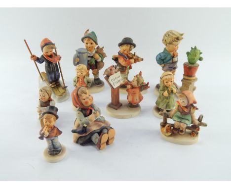 Eleven Hummel figures, including Skier, For Father, Happy Pastime, and Bird Duet.