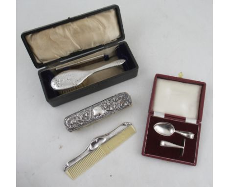 A cased silver babies spoon and push, together with two silver backed brushes and a comb