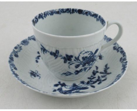 An early Worcester cup and saucer, the feather moulded body decorated in underglaze blue, painter marks, bearing a Klaber &am