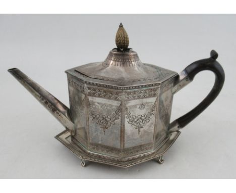 A Georgian silver tea pot and stand, of octagonal form, with engraved floral swags and leaf border, with pineapple finial, we