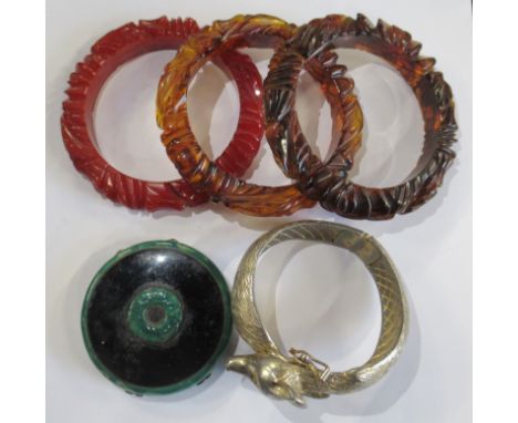 Three simulated amber oval carnelian bangles, together with a Castle Cliff fox gilt bangle, and a green enamelled 1930's comp