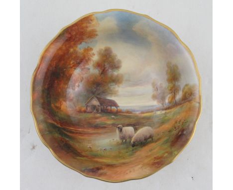 A Royal Worcester bowl, the interior painted with sheep autumnal trees, water and a barn with a landscape to the distance by 