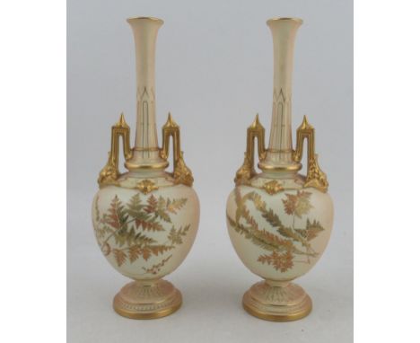 A pair of Royal Worcester ivory vases, decorated with finely gilded ferns, minor chip to one handle finial, shape number 1406