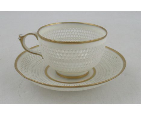 A Royal Worcester cup and saucer, with finely pierced body by George Owen, with gilt banded rims
