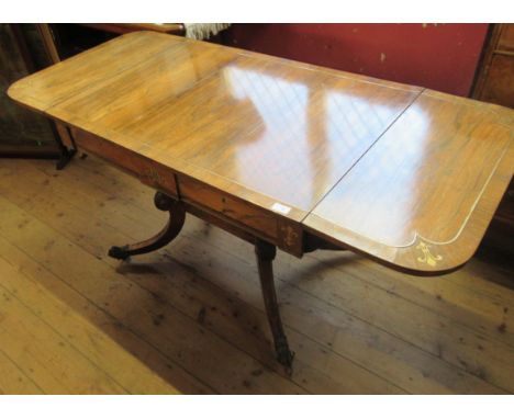 A Regency rosewood sofa table, with brass stringing, fitted with two frieze drawers, with central brass inlay, raised on four