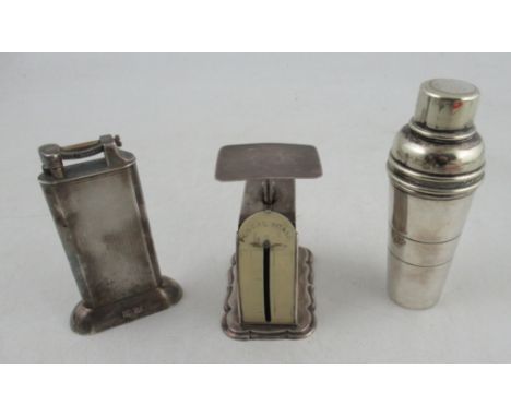 A Dunhill silver mounted tallboy type lighter, with engine turned decoration, together with a set of silver postal scales and