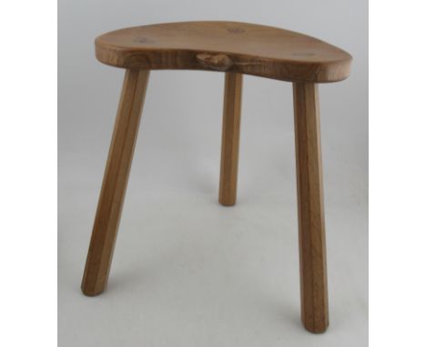 A Robert Thompson Mouseman three legged stool, with kidney shaped top, raised on three octagonal legs, width 15ins, height 18