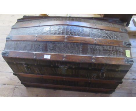 A dome top trunk, having wooden bands and leather effect finish, width 32ins, height 24ins&nbsp;