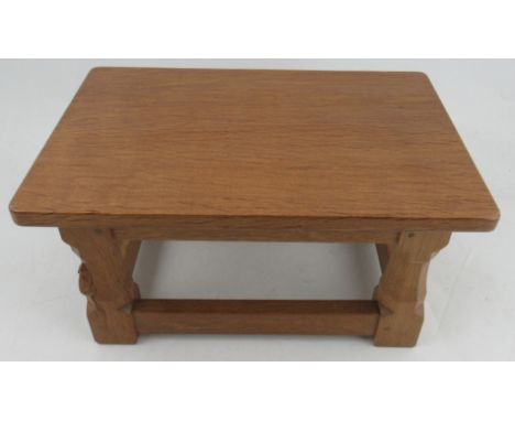 A Robert Thompson Mouseman rectangular stool, with adzed top, raised on octagonal legs united by stretchers, 16ins x 11ins&nb