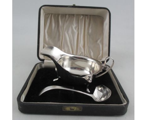 A cased silver sauce boat and ladle, weight 4oz