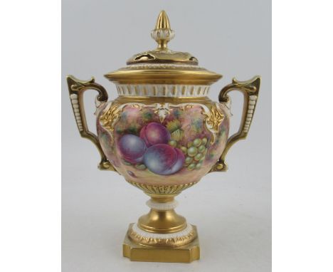 A Royal Worcester two handled covered vase, painted half round with fruit by Telford, raised on a square rebated pedestal bas