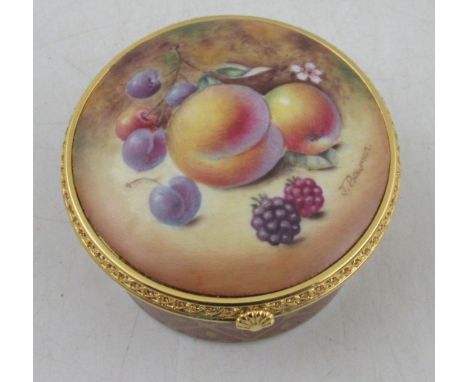 A circular Royal Worcester pill box, the hinged cover decorated with fruit to a mossy background by Bowman, diameter 2.75insC