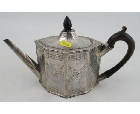 A Georgian silver tea pot, of octagonal form, with engraved floral swags and leaf border, with pineapple finial, weight 14oz 