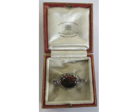 A boulder opal and diamond brooch, claw set oval cabochon boulder opal displaying orange, red, green and purple etc fire, wit