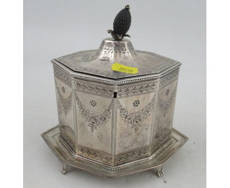 A Georgian silver tea caddy and stand, of octagonal form, with engraved floral swags and leaf border, with pineapple finial, 