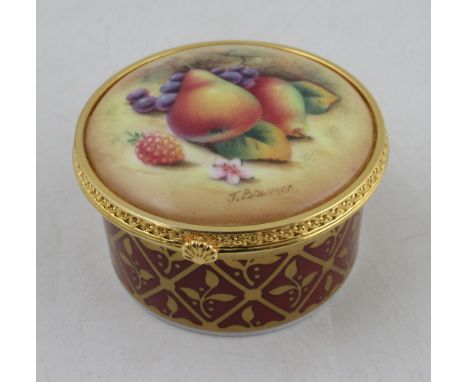 A circular Royal Worcester pill box, the hinged cover decorated with fruit to a mossy background by Bowman, diameter 2.75insC