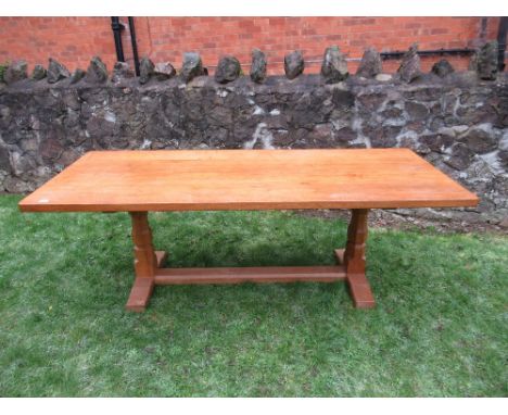 A Robert Thompson Mouseman rectangular top dining table, raised on two octagonal legs on sledge feet, united by stretchers, 8