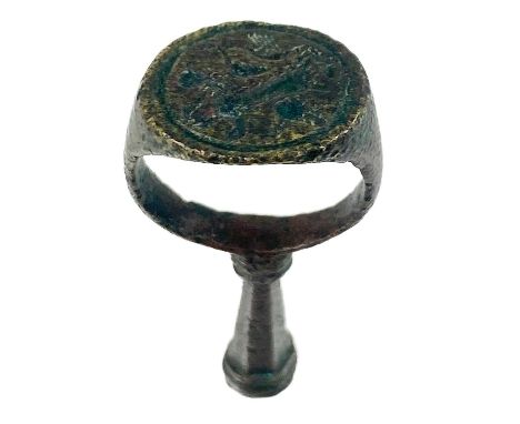 A 17th century copper-alloy seal and pipe tamper ring. The oval seal engraved with a rearing lion, the hexagonal section tamp