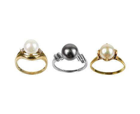 An 18ct cultured pearl set ring. Stamped K18, size R; together with two 9ct cultured pearl rings, one in white gold, size N, 