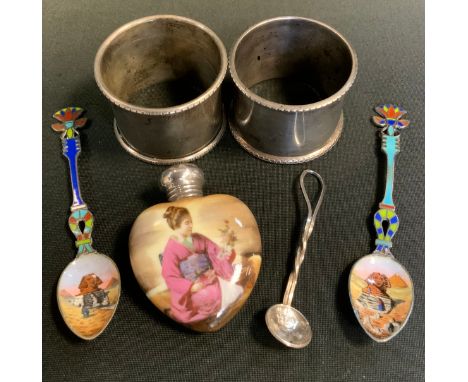 Two Continental silver and enamelled coffee spoons, enamelled with Sphinx, marked 800;  two silver napkin rings;  an Edwardia