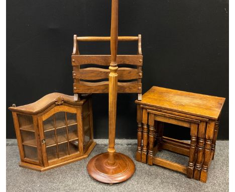 An early 20th century mahogany standard lamp;  an oak wall mountable display cabinet, serpentine top, canted corners, glazed 