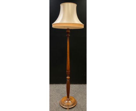 A turn of century mahogany standard lamp, turned, carved and reeded column, disc base, 193cm tall. 