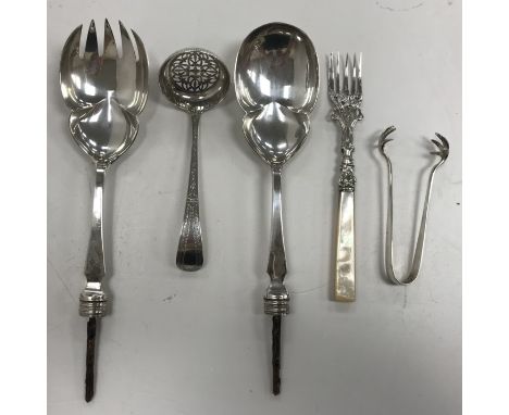A Victorian silver sifting spoon (by John, Edward, Walter & John Bateman, London, 1872), a pair of silver sugar tongs, a moth