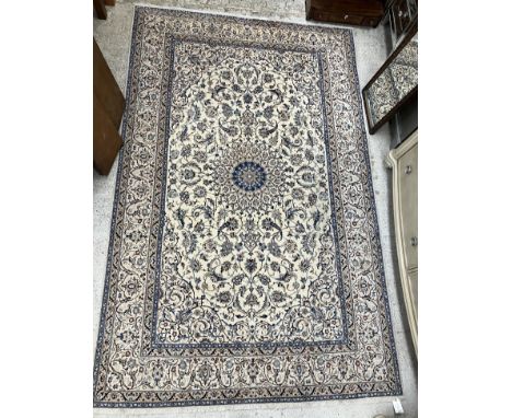 A part silk Nian carpet, the central panel set with floral decorated sunburst style medallion on a cream scrolling foliate de