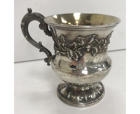 A William IV silver Christening mug of waisted form, the main body relief decorated with oak leaf and acorn band and inscribe