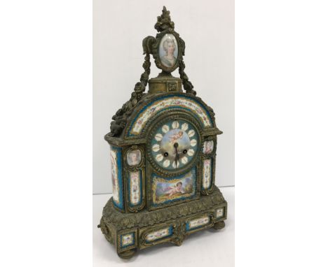 A 19th Century French gilt brass cased mantel clock set with hand-painted Sèvres style porcelain panels of portrait medallion