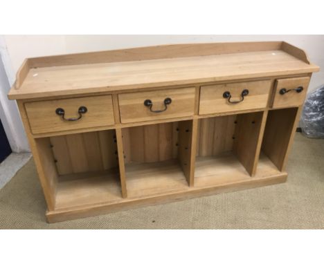 A modern oak side cabinet, the three quarter galleried top over four drawers with brass swan neck handles, over four recesses