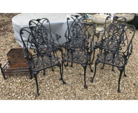 A set of six black aluminium metal garden chairs and a wrought iron fire grate 