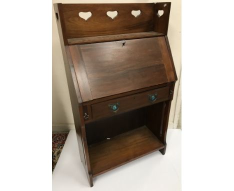 An Edwardian mahogany Arts & Crafts style student's bureau, the three quarter galleried top with heart motifs over a sloping 