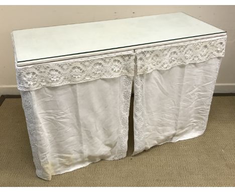 A white painted square fronted dressing table with cotton drapes 119 cm wide x 49 cm deep x 76.5 cm high including glass toge