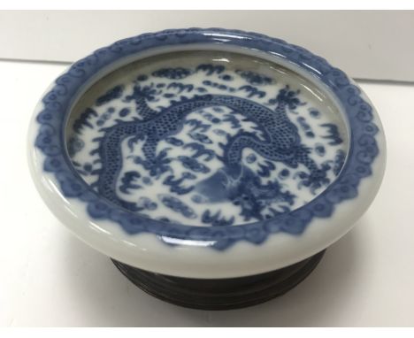 A Chinese blue and white dish, the centre field decorated with five toed dragon chasing a pearl, within a cloud decorated inw