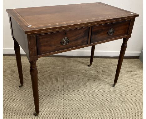 A mahogany and cross banded two drawer side table in the Regency taste raised on turned legs to brass caps and castors 100.5 