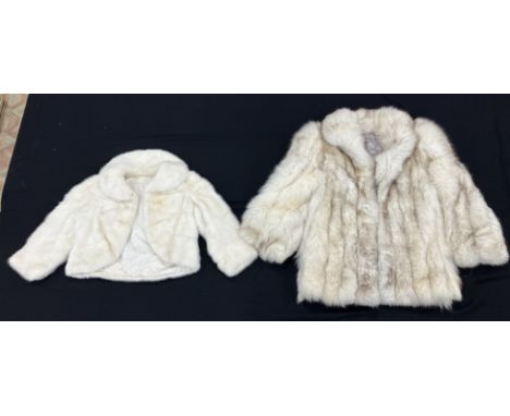 A mid 20th Century Debenham and Freebody fur jacket in white, the sateen lining inscribed "Debenham and Freebody and T.D.E.C.