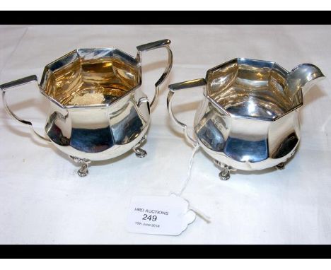 A silver cream jug with the matching sugar bowl 