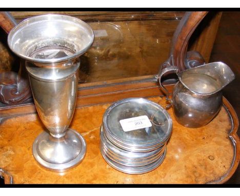 A silver trumpet vase, cream jug, together with coasters 