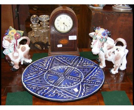 Edwardian mantel clock, together with pottery cows and charger 