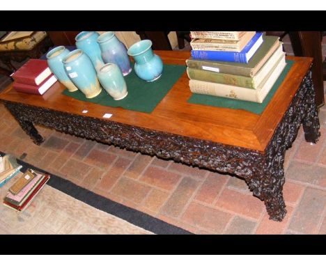 A carved Chinese hardwood low table - 156cm long CONDITION REPORTSlight marks to top but generally in good condition. Top lig