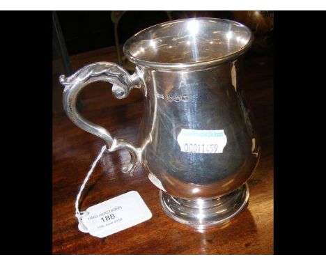 An 11cm high silver tankard CONDITION REPORTGood condition. Engraved inscription to the front. Walker and Hall hallmarked sil